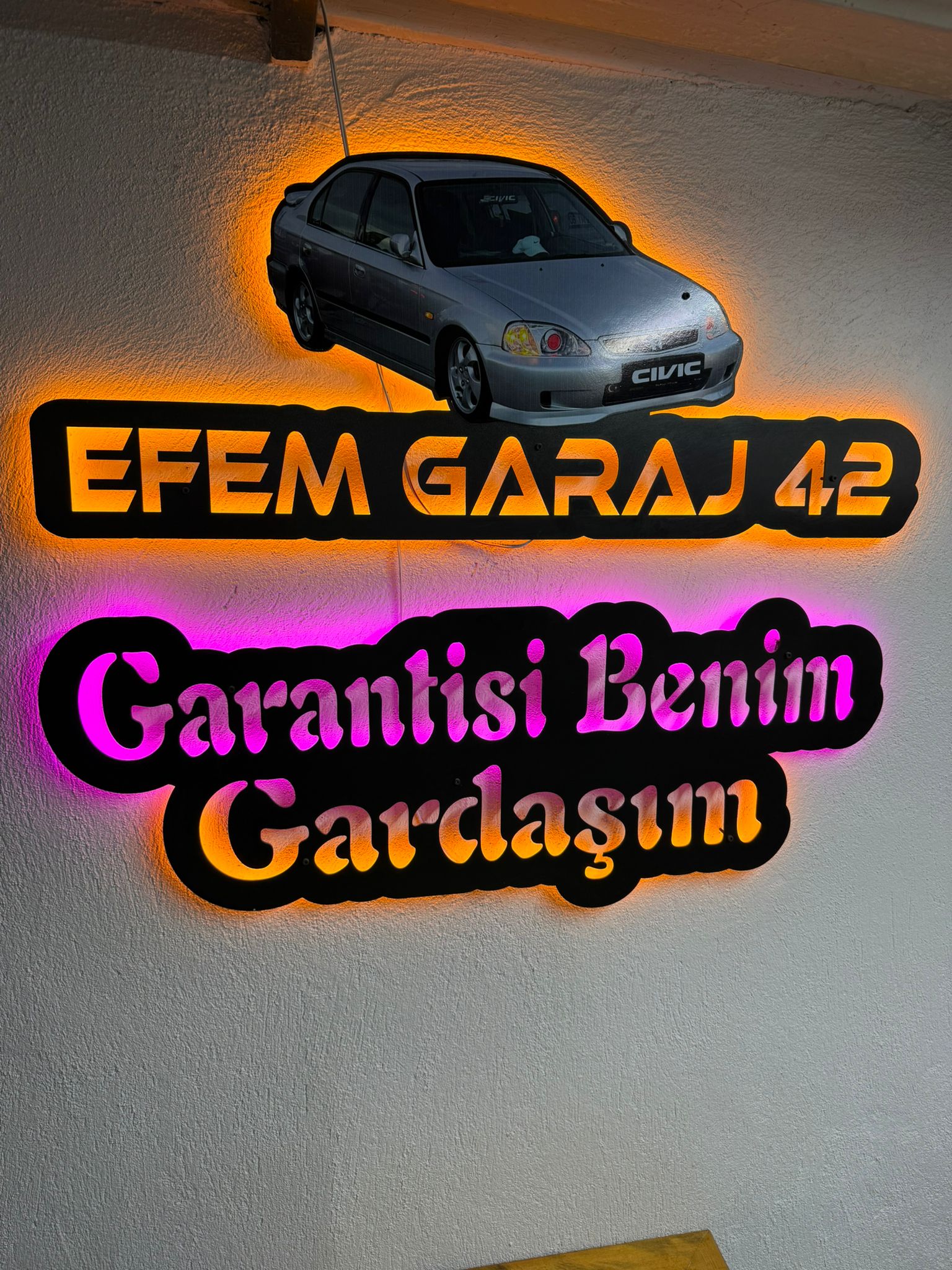 Turuncu ışıklı Efem Garaj 42 tabelası ve Honda Civic